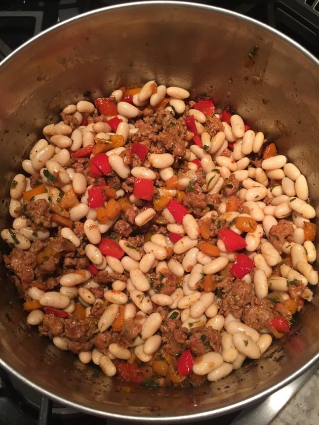 Sausage bean soup being cooked in pot