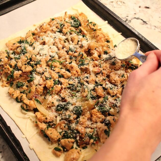 Adding Chicken Sausage Tart toppings to pastry dough 