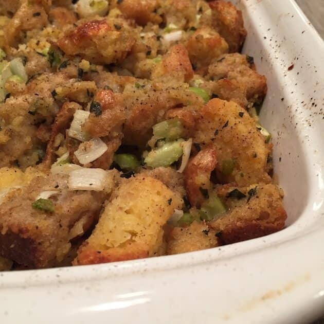 Partial casserole dish of cornbread stuffing