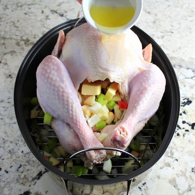 Instructions how to prepare a Thanksgiving Turkey  - adding olive oil to skin