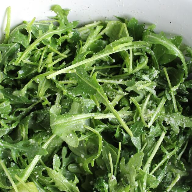 Close up Arugula leaves coated with Parmesan &amp; Lemon