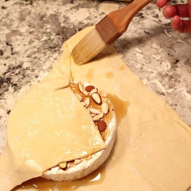 Wrapping Baked Brie in Puff Pastry using brush with egg wash 