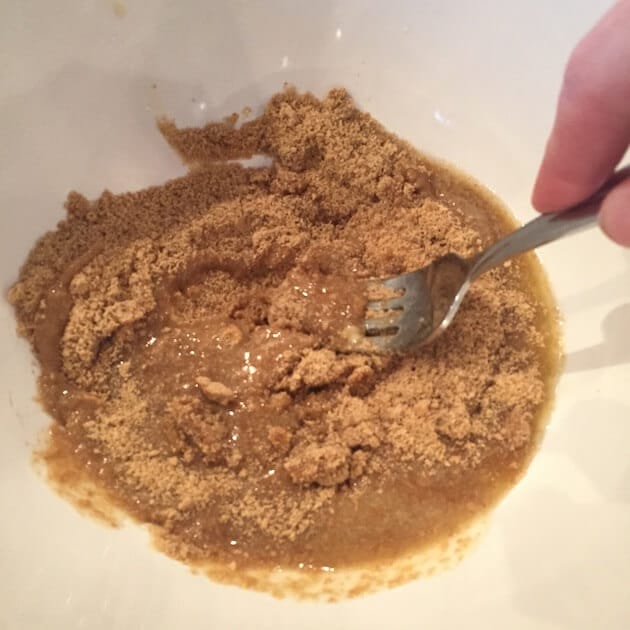 Mixing butter and graham cracker crumbs for chocolate hazelnut tart