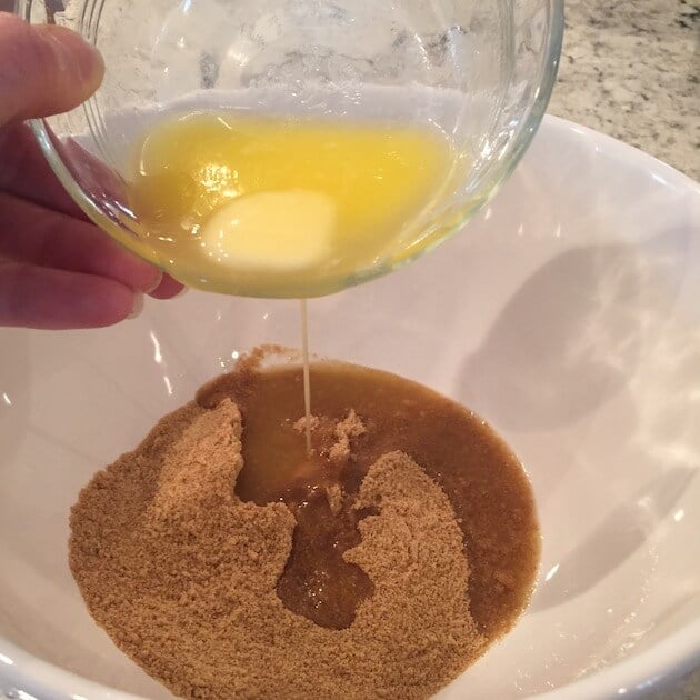 adding butter to graham cracker crumbs for tart crust