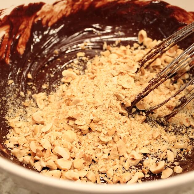 Mixing chopped Hazelnuts into chocolate 