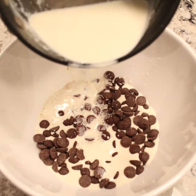 Pouring warm cream over chocolate chips