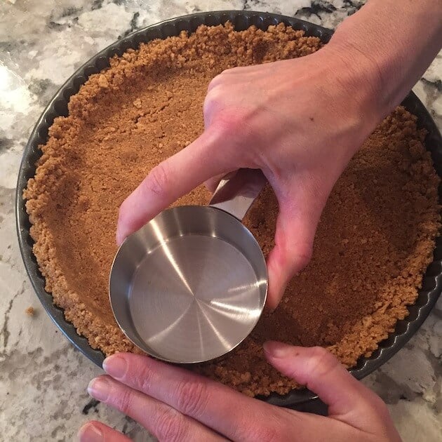 Pressing crust into tart pan for Chocolate Hazelnut Tart crust