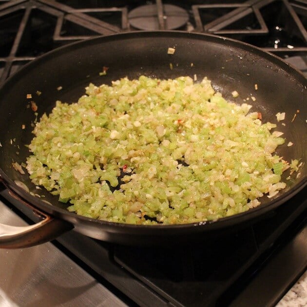 Celery and onions cooking in saute pan 