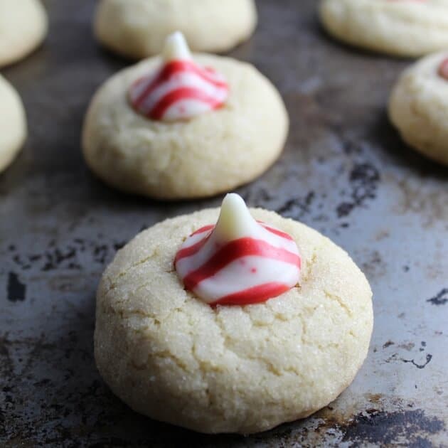 Thumbprint Cookies with Peppermint Kiss centers on a baking sheet.