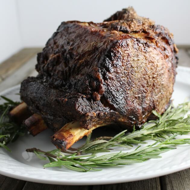 Standing Rib Roast on platter with rosemary