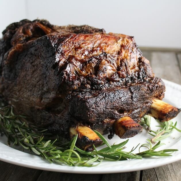 Cooked Standing Rib Roast on Platter with Rosemary