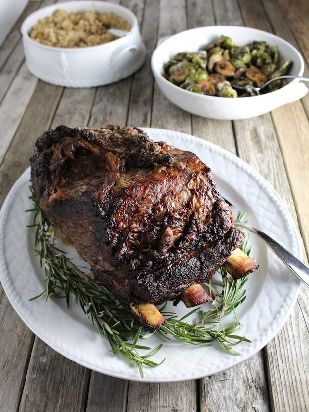 Sliced Standing Rib Roast Serving platter with rice and vegetable side dishes