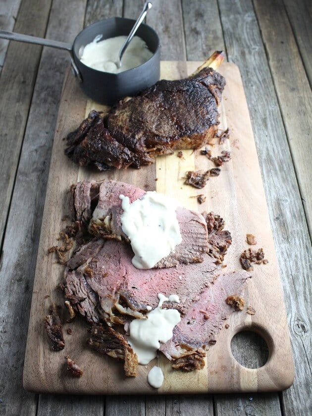 Standing Rib Roast on cutting board with horseradish sauce