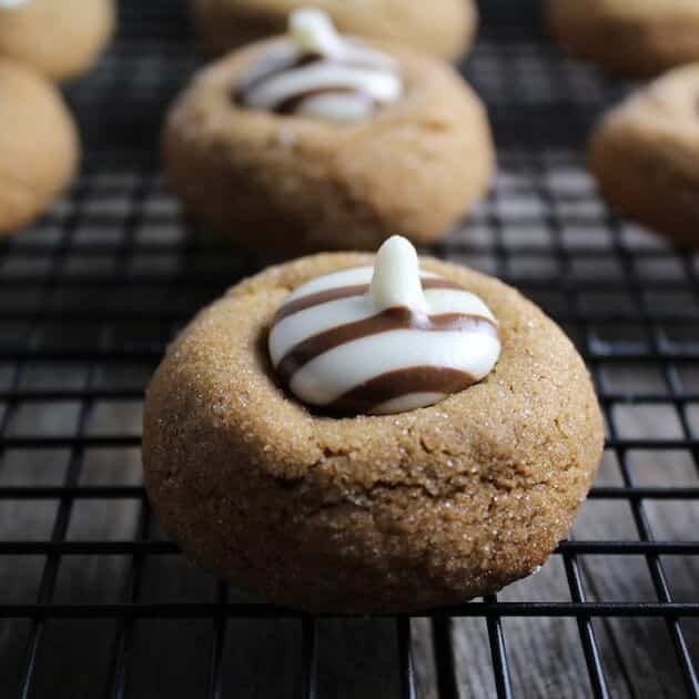 Gingerbread Thumbprint Cookies with white chocolate centers, on a wire cooling rack