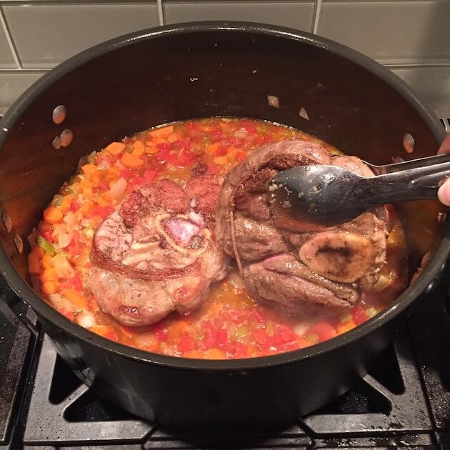 Adding seared Veal shanks back into Dutch oven with veggies