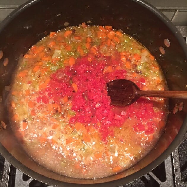 Sautéing veggies with white wine, chicken stock and spices in a dutch oven.