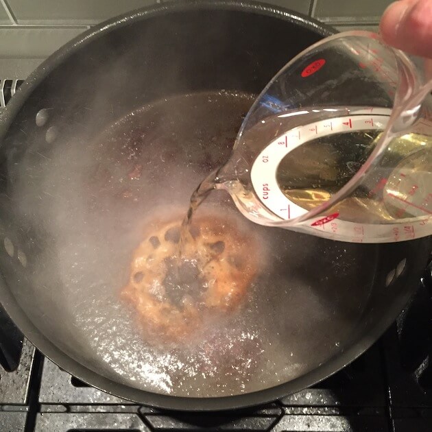 Deglazing a dutch oven with white wine after searing Veal Osso Buco