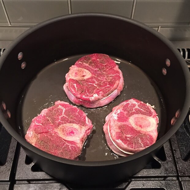 Searing the meat in a dutch oven.