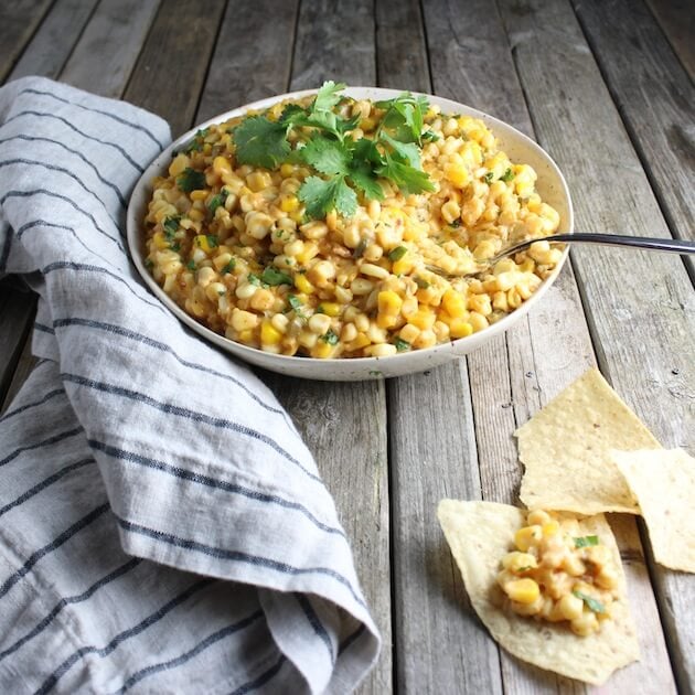 Corn dip with jalapeno, onion, and cheddar on a farm table