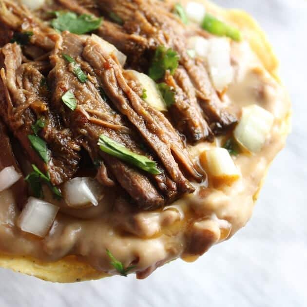 Beef Barbacoa on refried beans