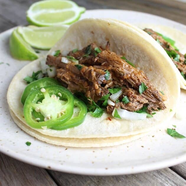 soft taco with slow cooked beef, jalapenos, and lime