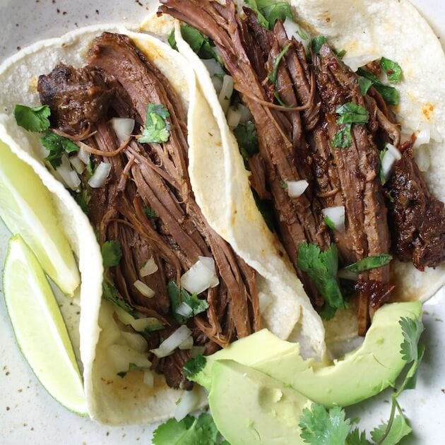 Two beef tacos with avocado