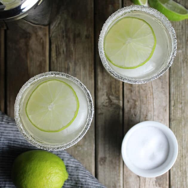 Two margarita glasses with salted rims