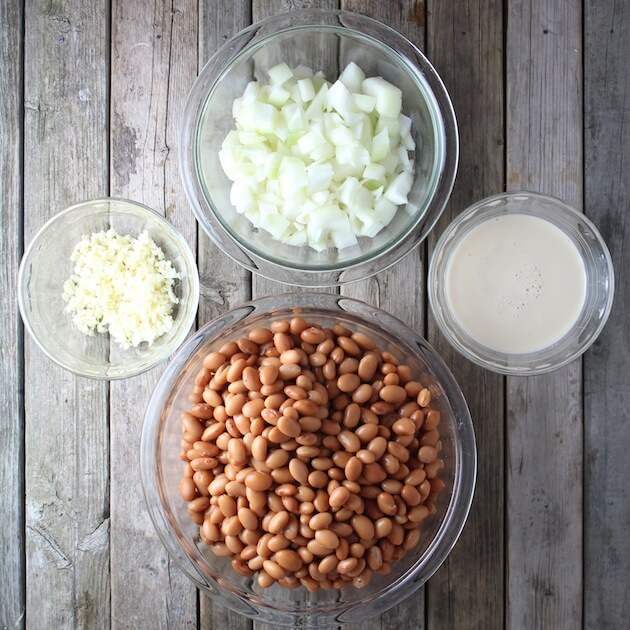 Glass bowls with Pinto beans, garlic, and onion for refried beans 