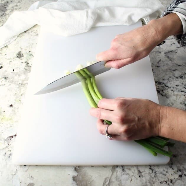 Chopping green onions on a cutting board