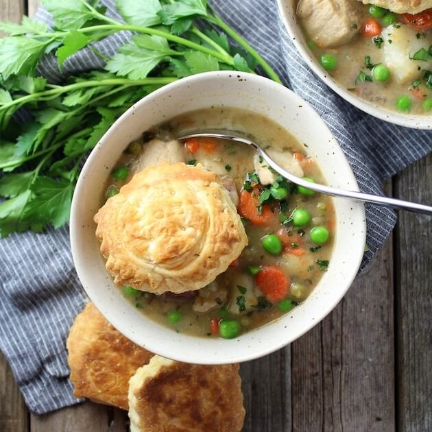 Bowl of Chicken Pot Pie Soup with puff pastry shell on top 