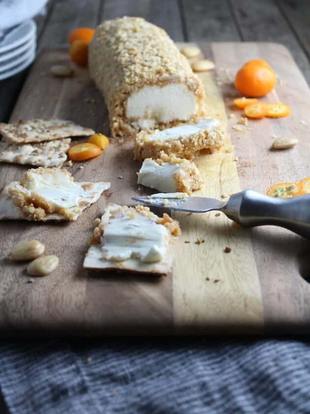 Goat Cheese with Marcona Almonds and Honey on cutting board