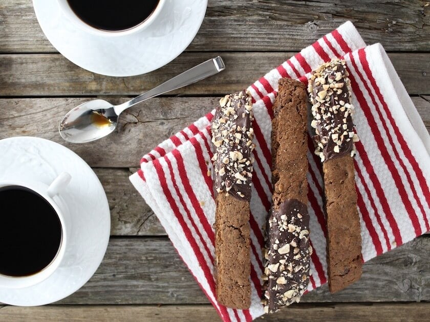 Chocolate Chip Hazelnut Biscotti on a napkin with coffee