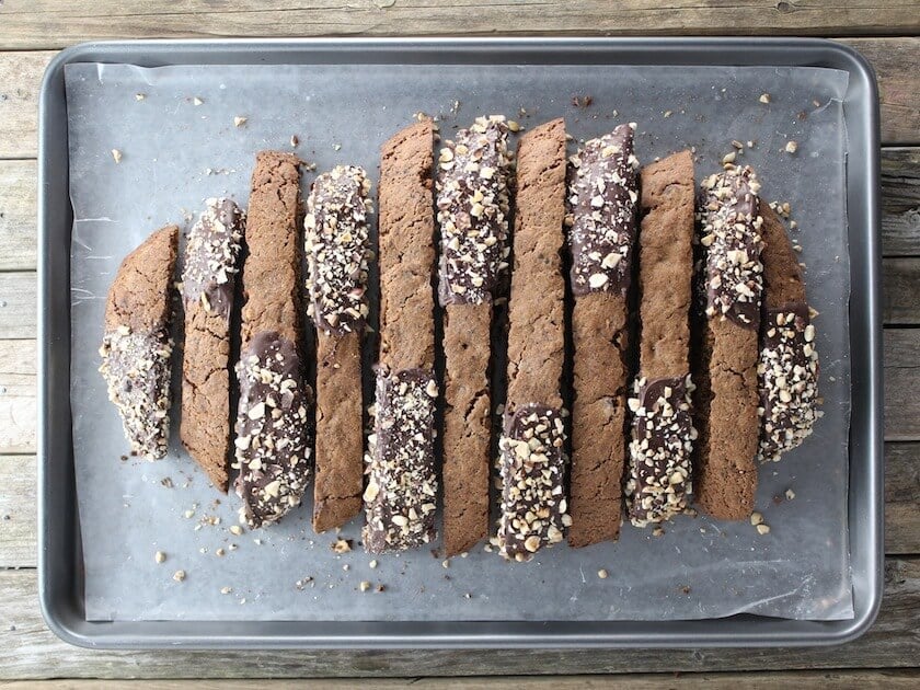 Baking sheet with a batch of Chocolate Coffee Hazelnut Biscotti on wax paper