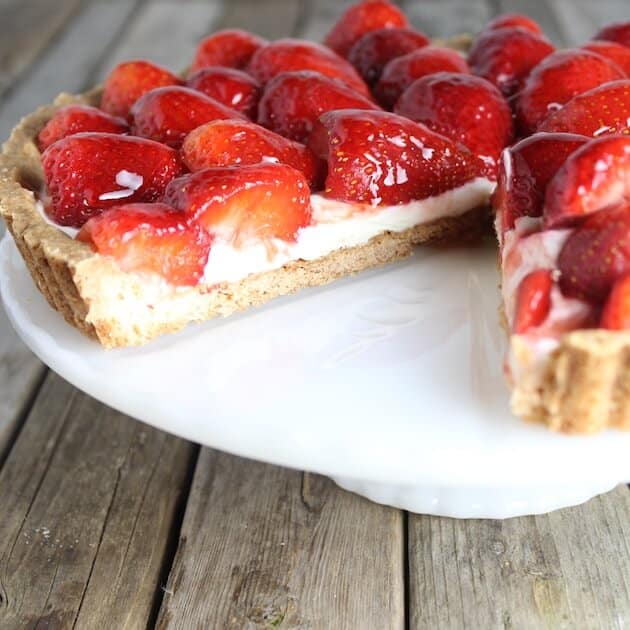 Strawberry Tart on a platter with slice cut out
