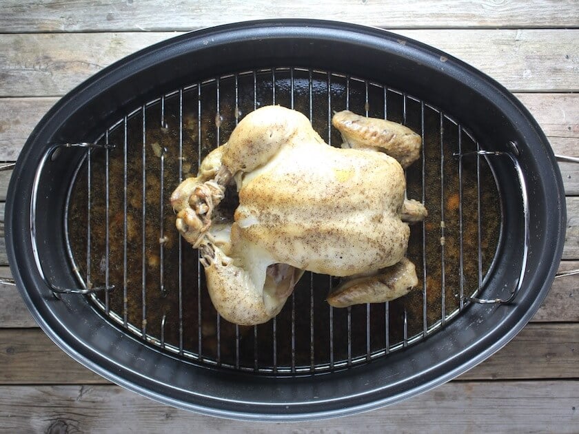 Whole chicken smoked in  a roasting pan 