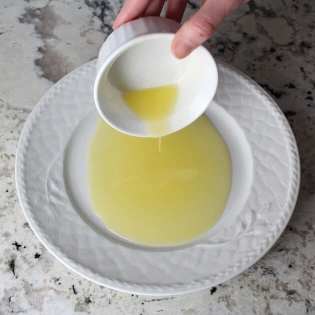 Adding melted butter to plate