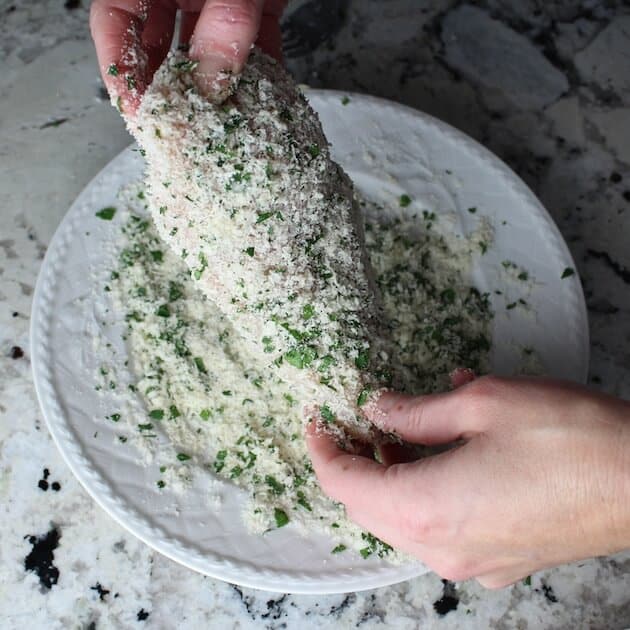 Coating chicken breast in parmesan herb mixture