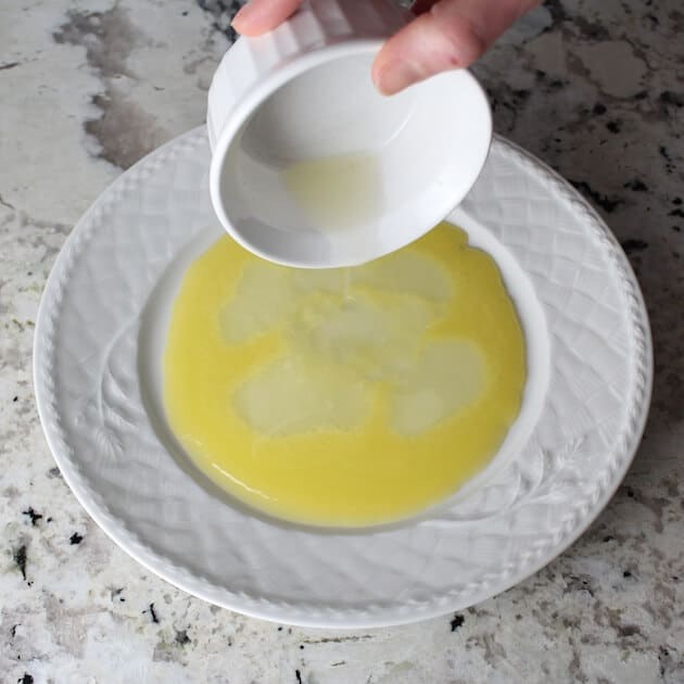 Adding lemon juice to plate with melted butter
