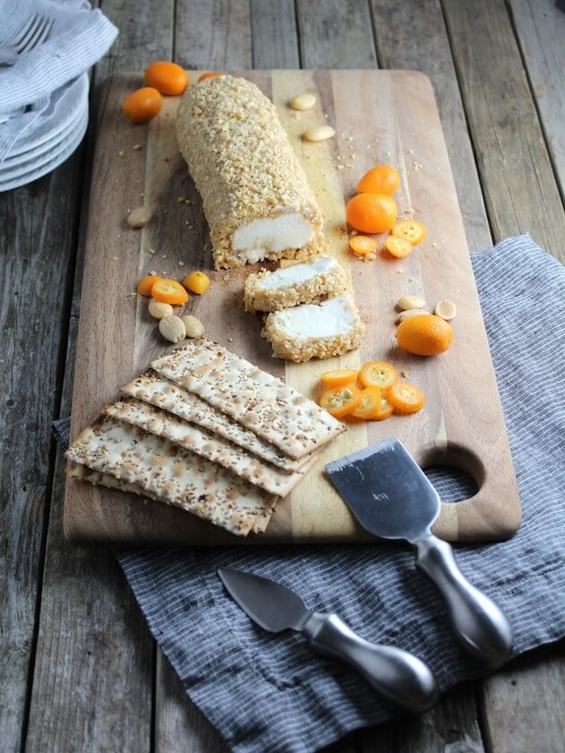 Goat Cheese with Marcona Almonds and Honey on cutting board