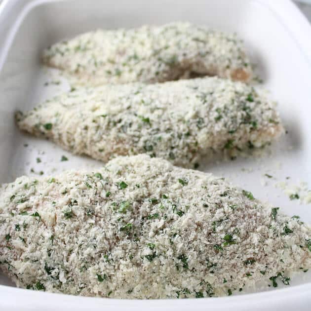 Coated chicken breasts in casserole dish ready to bake