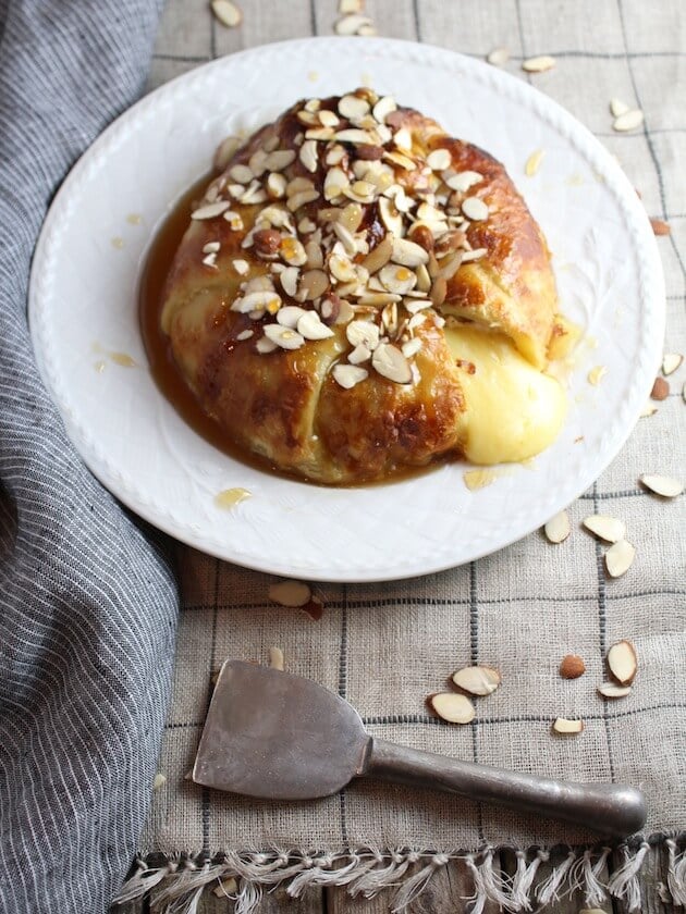 Baked Brie in Puff Pastry with Honey and Almonds on plate