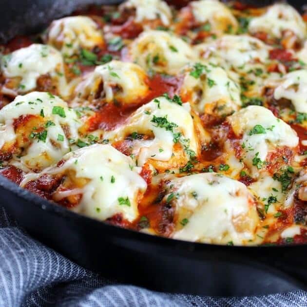 Closeup Italian Meatballs in skillet covered in mozzarella 