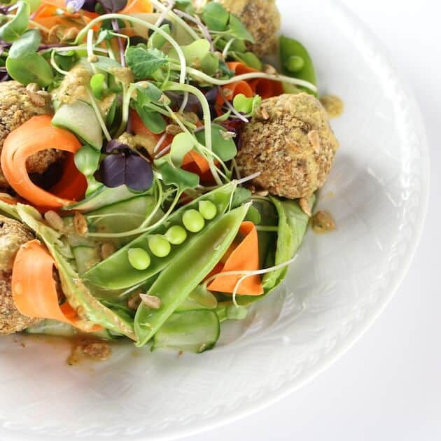 Plate full of colorful fresh ribboned vegetables with Vegetarian Meatballs 