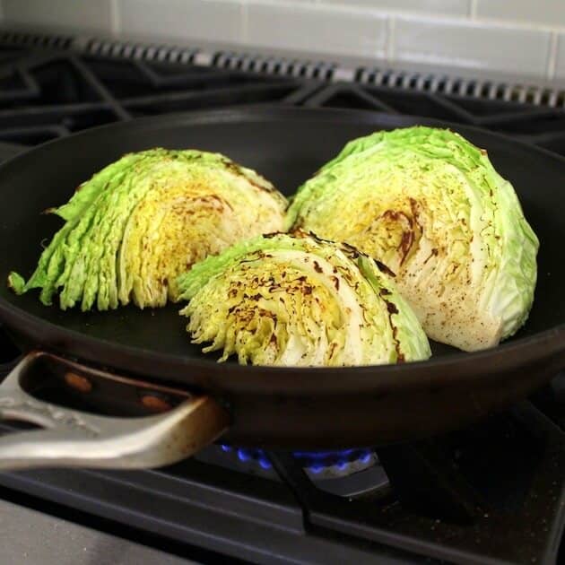 Sweet And Spicy Roasted Cabbage getting seared on stovetop