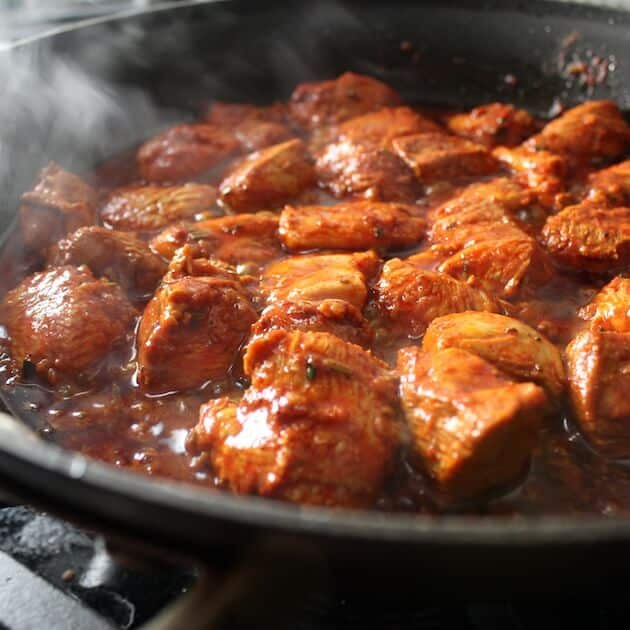 Moroccan Chicken simmering in skillet on stovetop