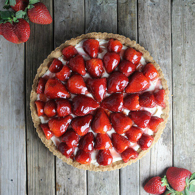 Strawberry Mascarpone Tart with shortbread crust on farm table 