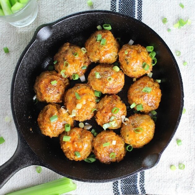 Meatballs in a skillet with green onions 