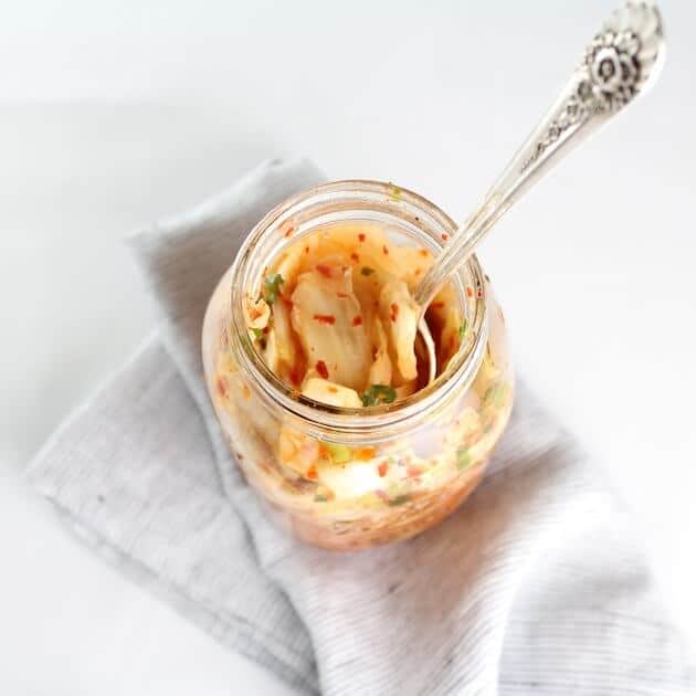 Spoon in mason jar of Homemade Kimchi
