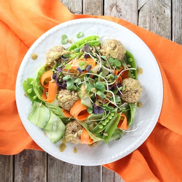 Plate full of Vegetarian Meatballs on an orange napkin