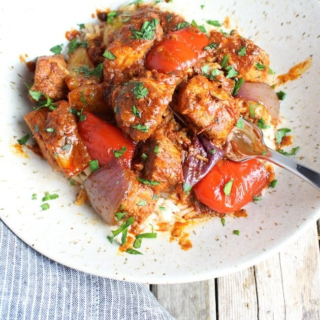 Lemon Harissa Chicken, Peppers and Onions on plate with fork